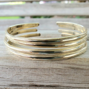 Stack of textured jeweler's brass bangle bracelets