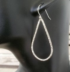 Long Textured Teardrop Sterling Silver French Wire Earrings shown on mannequin