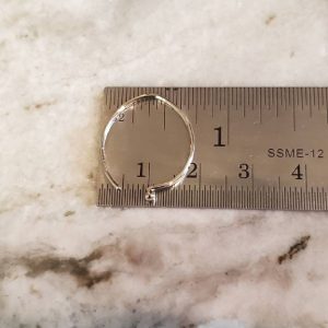 Hammered Solid White 14k Gold Wire Earrings shown on a ruler to indicate they are roughly 3/4" wide
