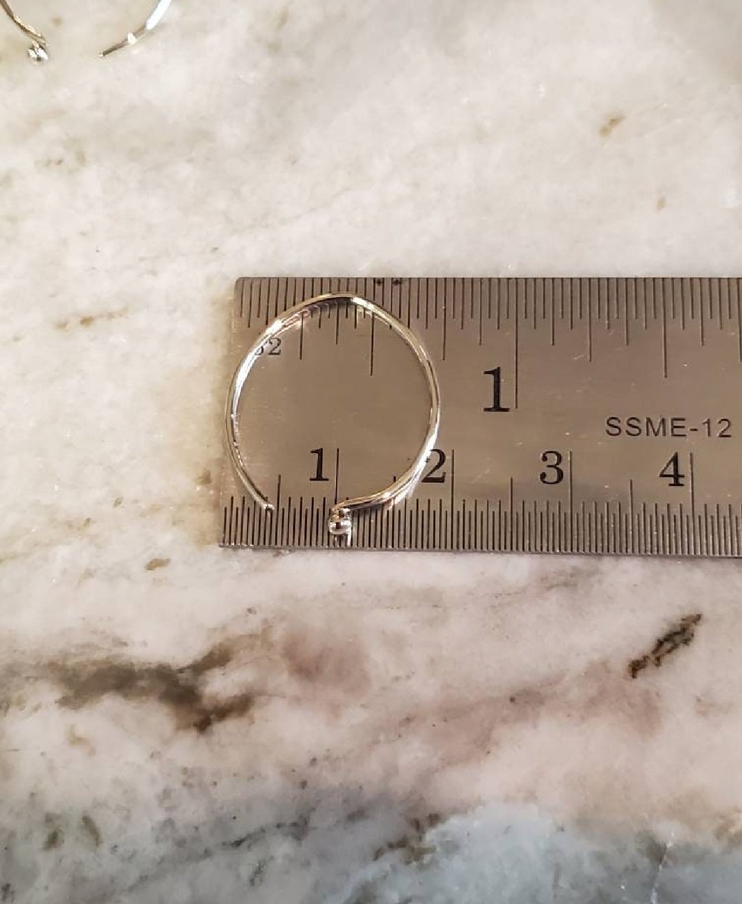 Hammered Solid White 14k Gold Wire Earrings shown on a ruler to indicate they are roughly 3/4" wide