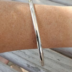Smooth Finish Chunky Sterling Silver Stacking Bangle shown on model's arm showing thickness
