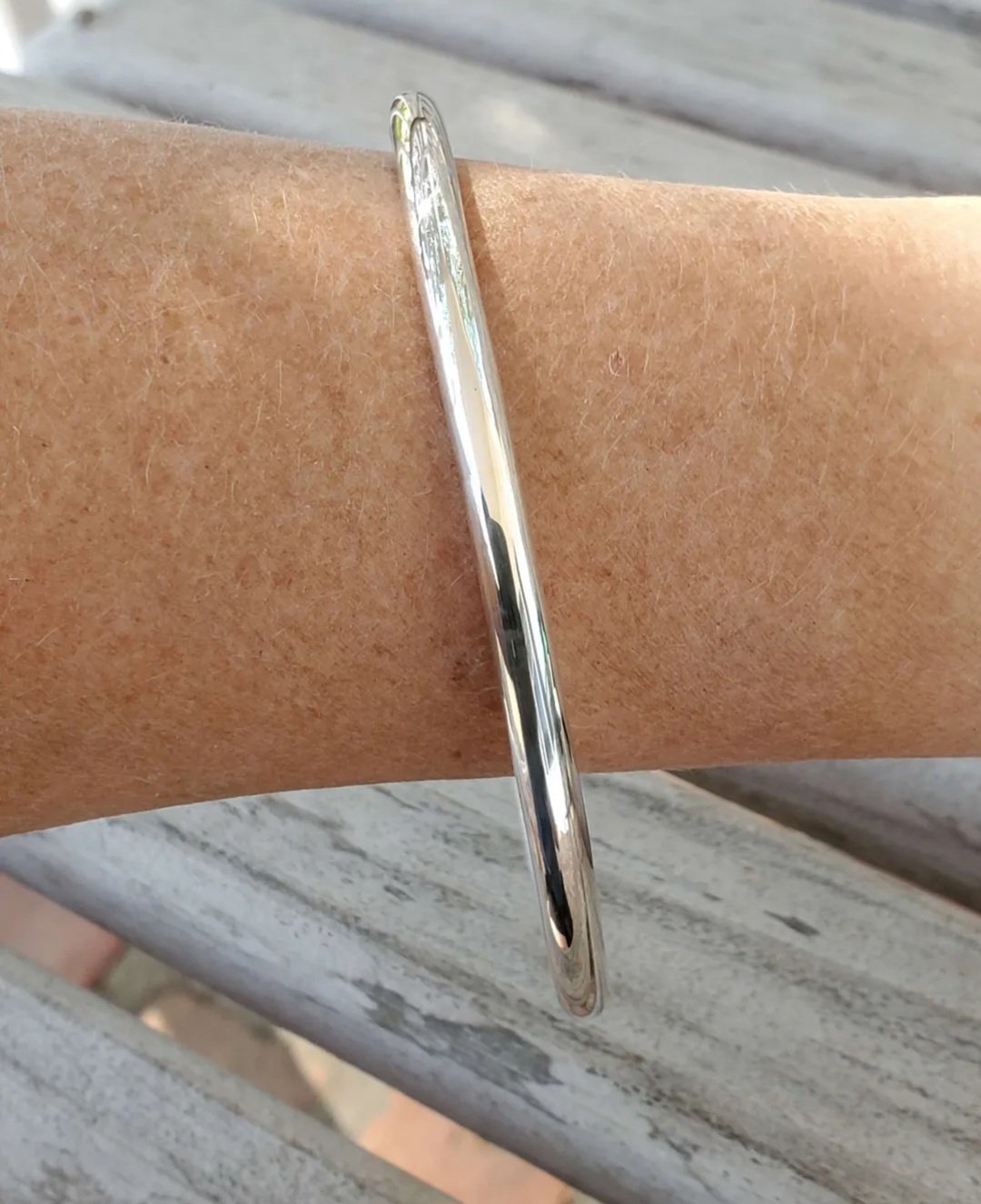 Smooth Finish Chunky Sterling Silver Stacking Bangle shown on model's arm showing thickness
