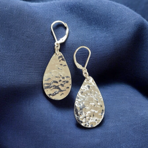 Hammered Sterling Silver Teardrop Level Back Earrings on a blue background