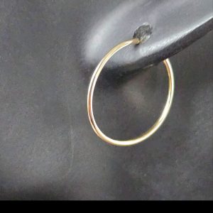 14K Yellow Gold Endless Hoop Earrings shown on a mannequin from the side