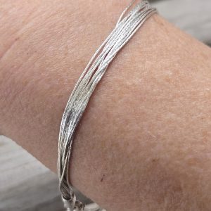 Finely Stranded Sterling Silver Bracelet with Lobster Clasp showing up close view of the textured strands