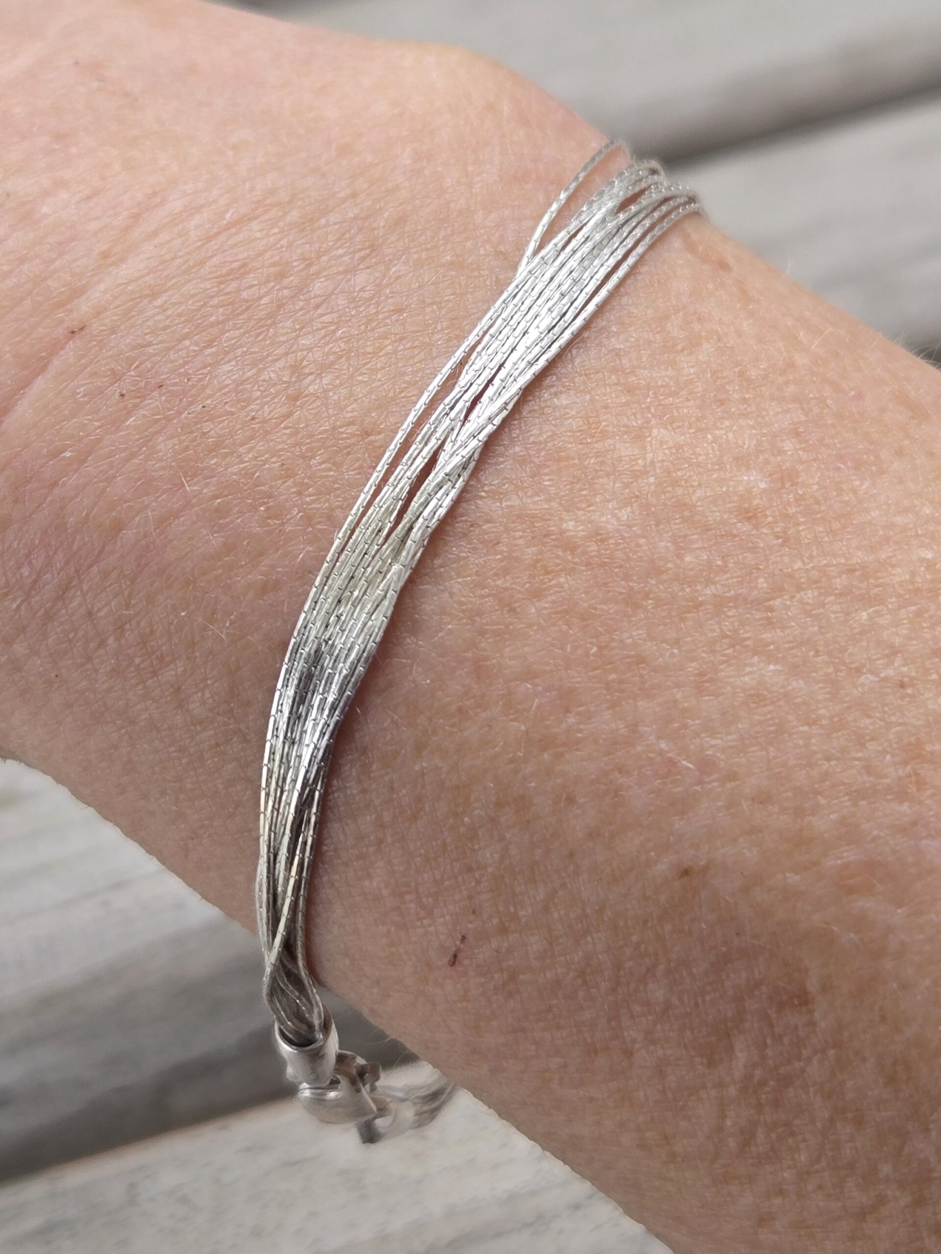 Finely Stranded Sterling Silver Bracelet with Lobster Clasp showing up close view of the textured strands