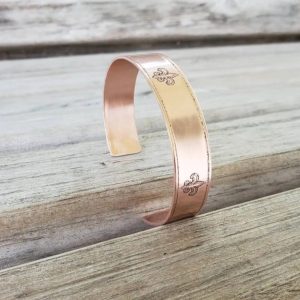 Fleur-de-Lis etched Copper Cuff Bracelet showing the carvings and the lined edges, as well as the rounded corners at the opening.