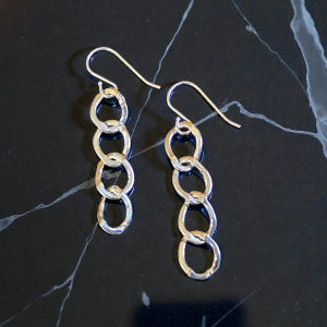Oval Link Sterling Silver French Wire earrings on a marble surface to enhance the look of the silver links, the french wire, and the polished finish.