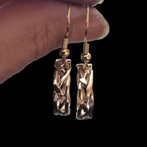 Braided Jeweler's Brass Round Earrings on French wire held by model's hand to indicate how they drop.